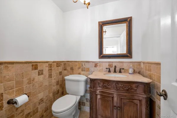 a bathroom with a sink a toilet and a mirror