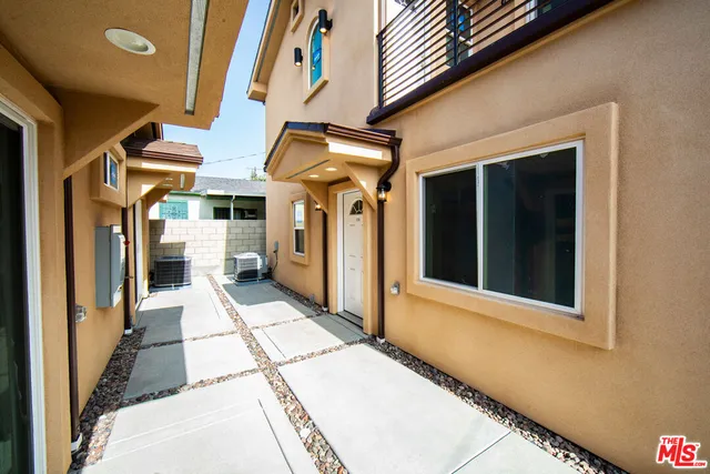 a view of a balcony with refrigerator and outdoor view