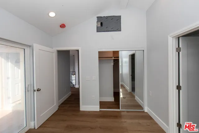 a view of a hallway with wooden floor and entryway