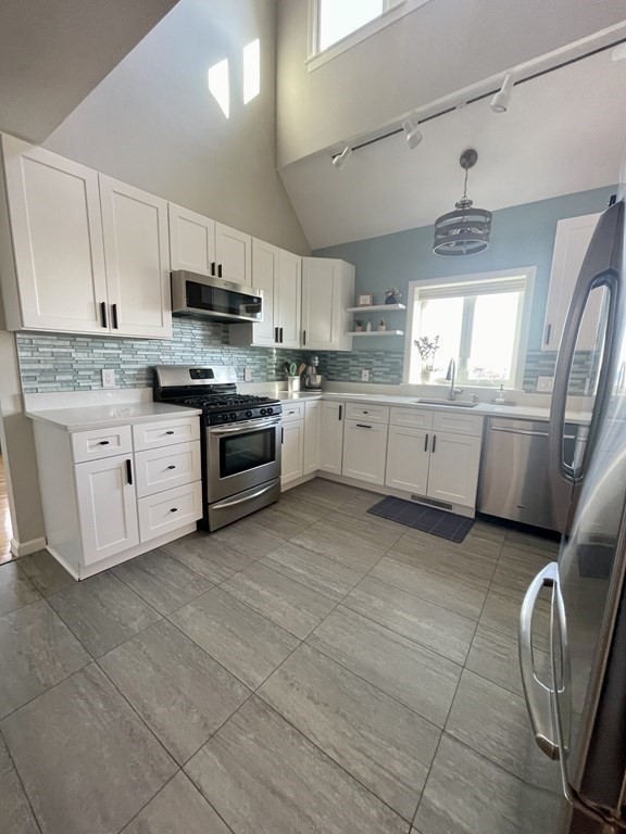 1 Lily Pond Road Plymouth, MA 02360 - Photo 14 of 40 a kitchen with stainless steel appliances granite countertop a stove sink and cabinets