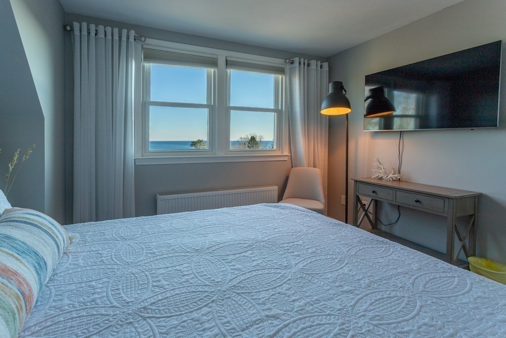 1 Lily Pond Road Plymouth, MA 02360 - Photo 32 of 40 a bedroom with a bed and flat tv screen on the dresser