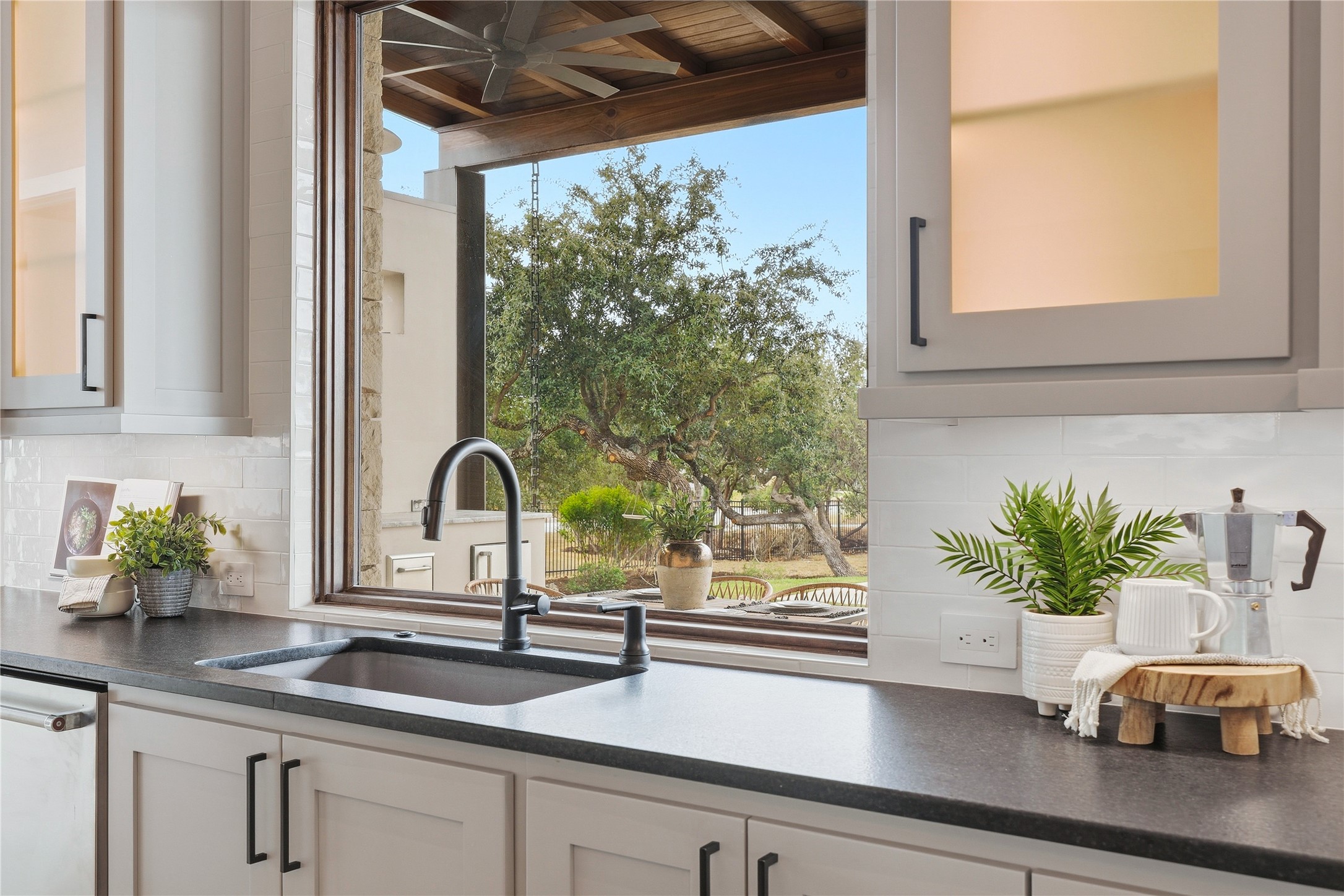 449 Ranch Falls Fair Oaks Ranch, TX 78015 - Photo 14 of 39 Generous kitchen windows overlook mature trees and frame a scenic view of the outdoor landscape.