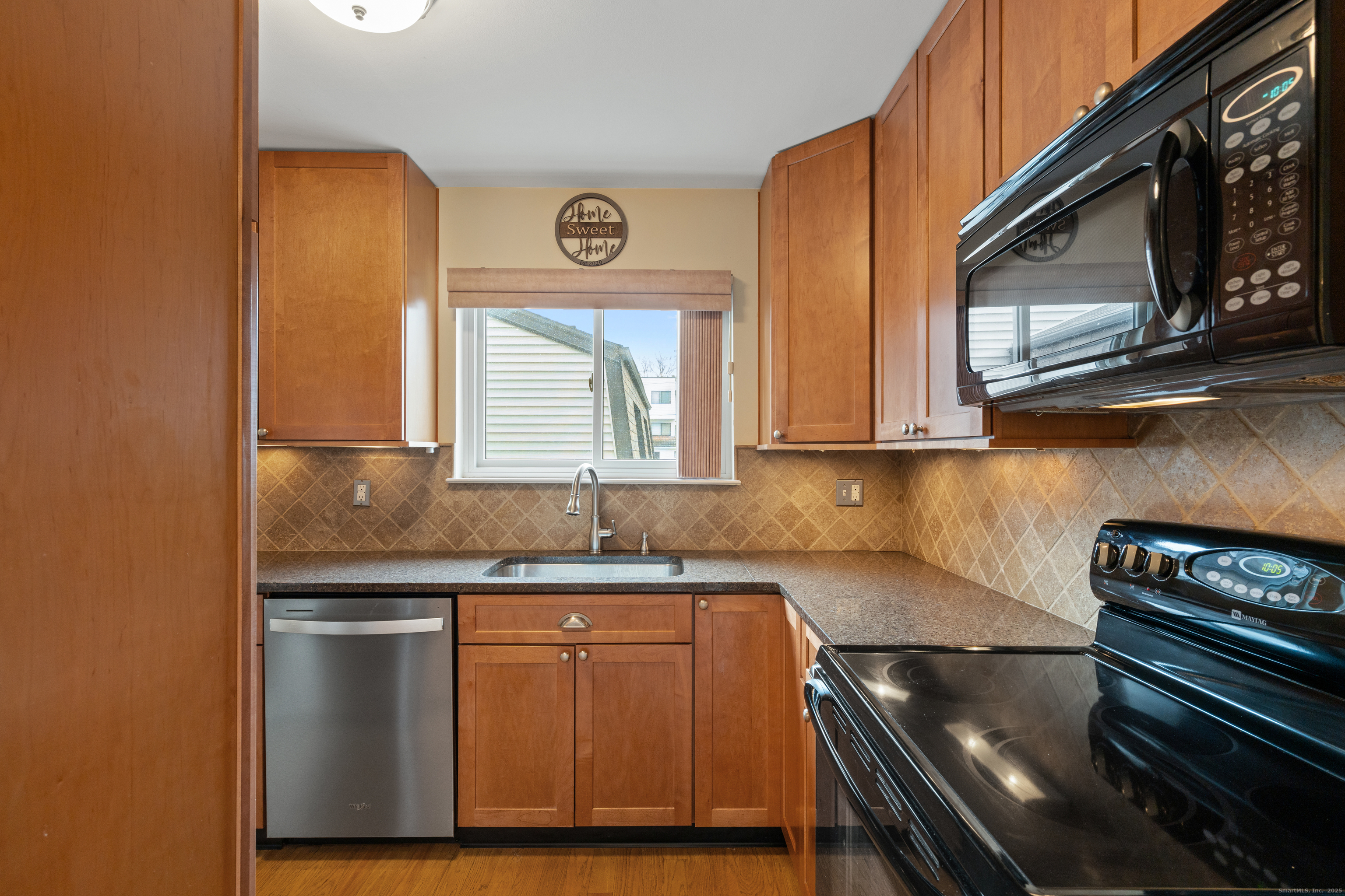 37 Riverside Avenue, Unit D Stamford, CT 06905 - Photo 15 of 29 a kitchen with stainless steel appliances granite countertop a sink and a stove