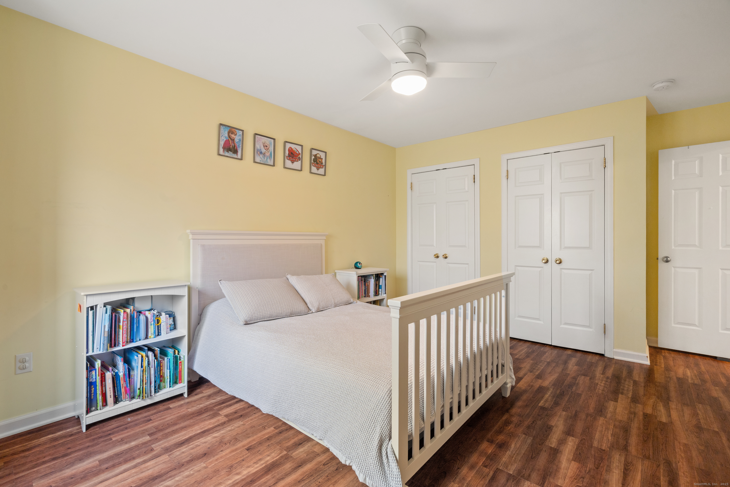 37 Riverside Avenue, Unit D Stamford, CT 06905 - Photo 19 of 29 a bedroom with a bed and a book shelf