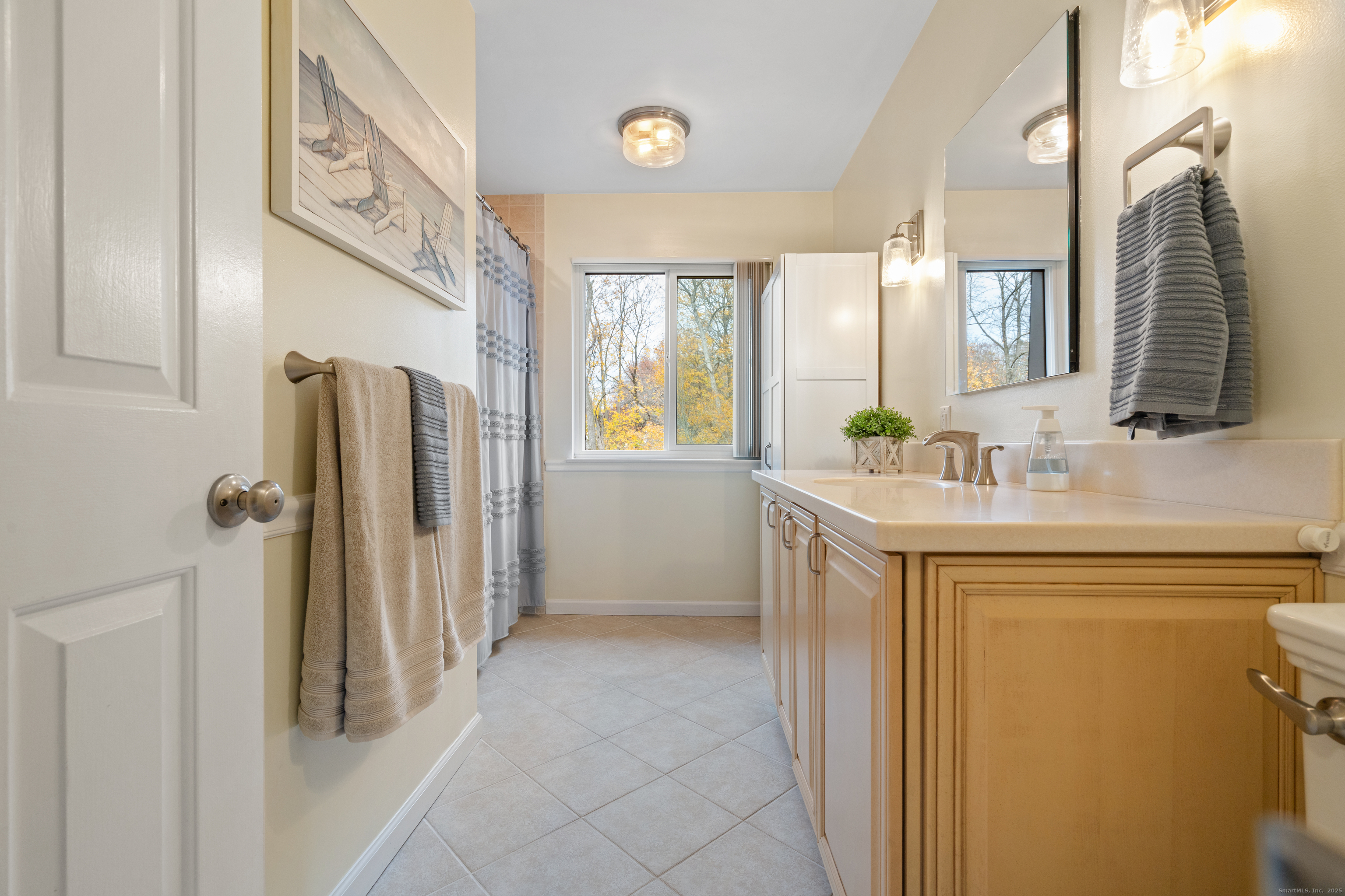 37 Riverside Avenue, Unit D Stamford, CT 06905 - Photo 20 of 29 a bathroom with a sink and a mirror