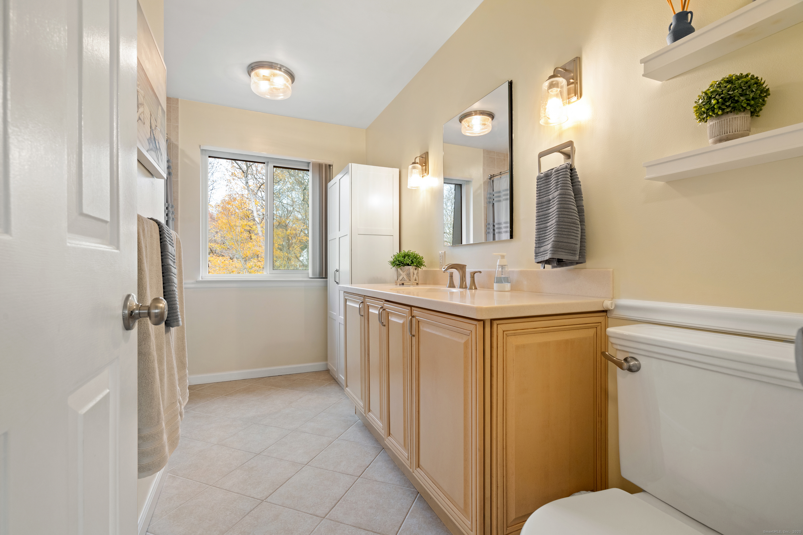 37 Riverside Avenue, Unit D Stamford, CT 06905 - Photo 21 of 29 a bathroom with a double vanity sink mirror and toilet