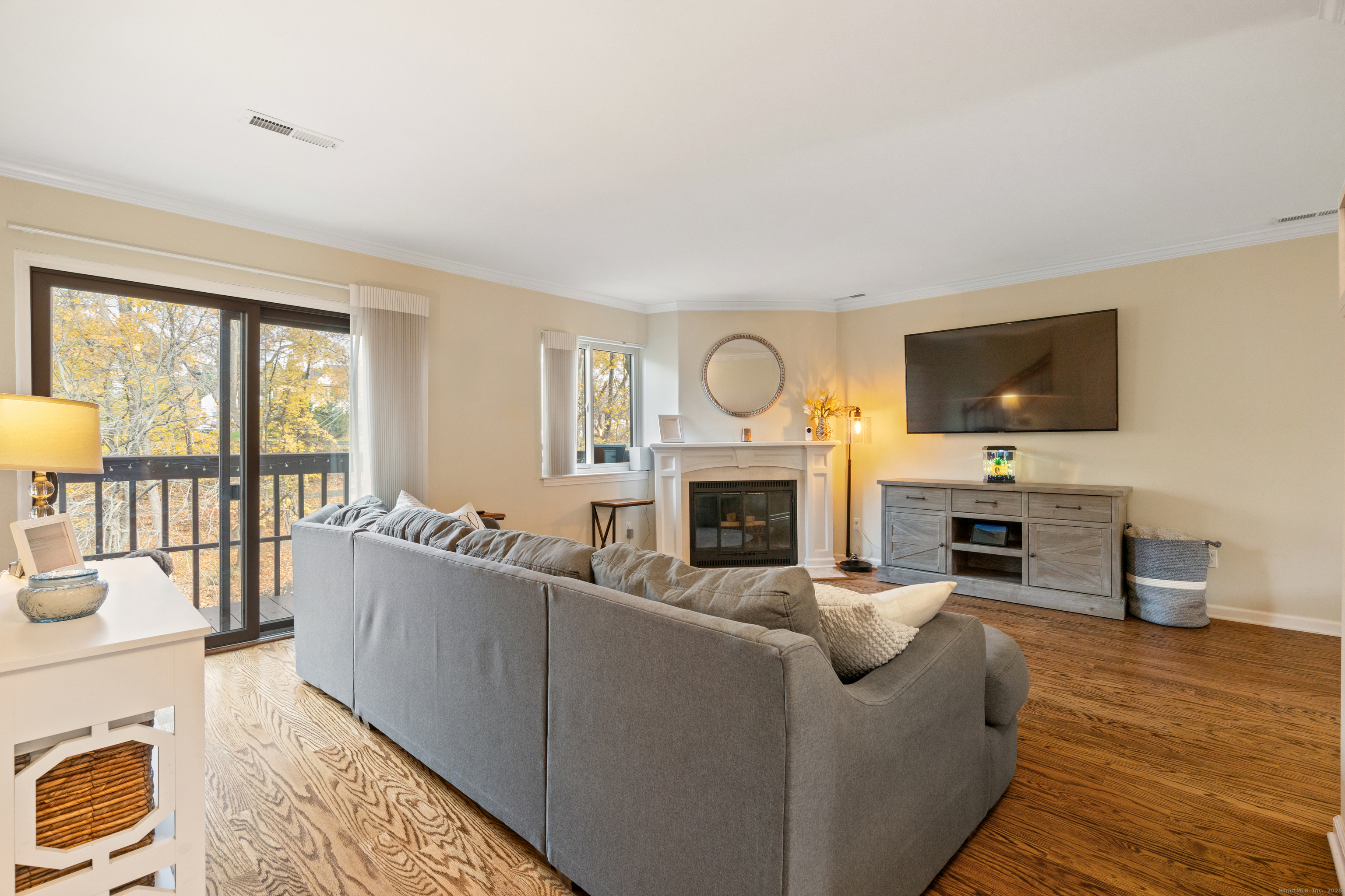 37 Riverside Avenue, Unit D Stamford, CT 06905 - Photo 6 of 29 a living room with furniture a fireplace and a flat screen tv