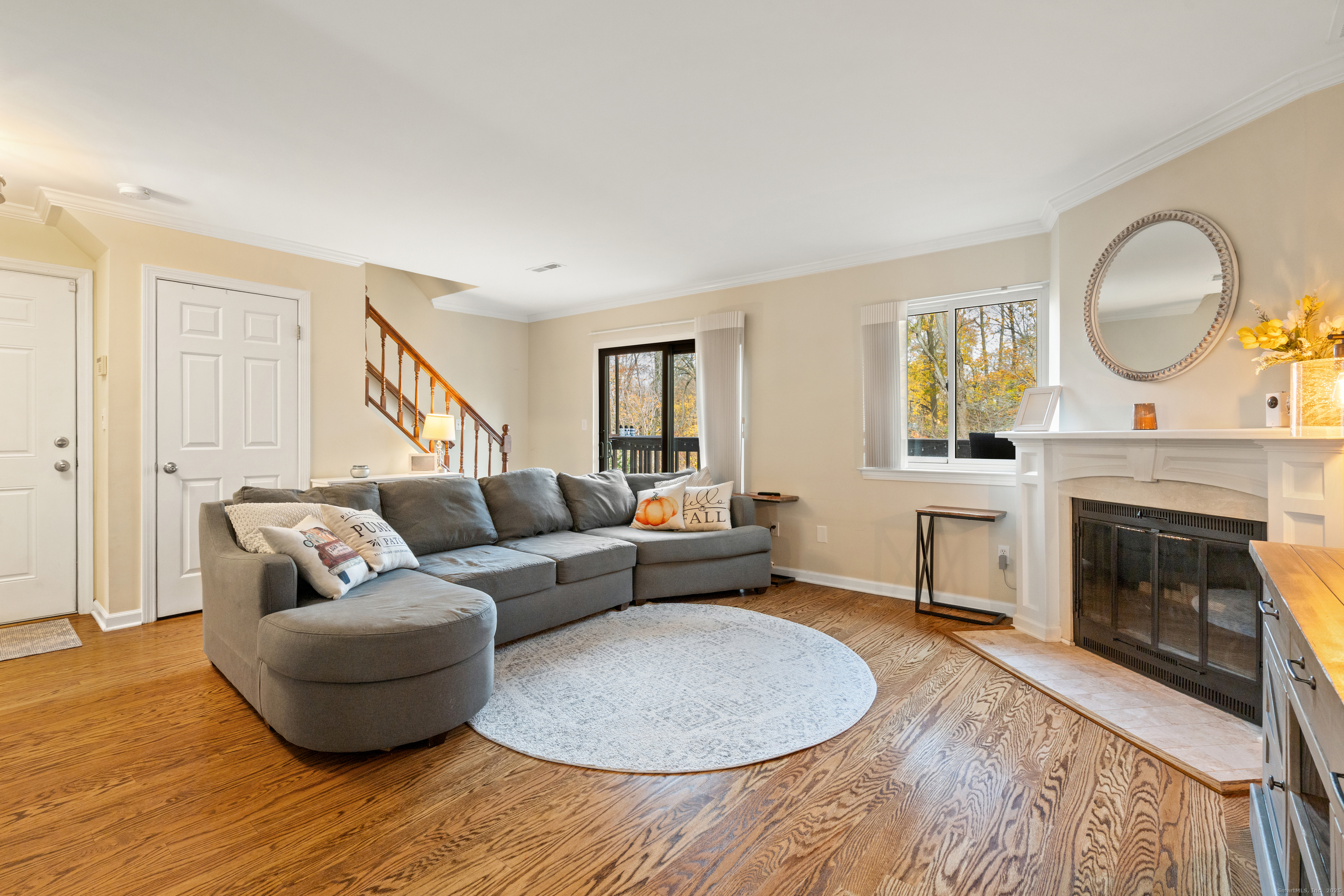 37 Riverside Avenue, Unit D Stamford, CT 06905 - Photo 7 of 29 a living room with furniture a fireplace and a potted plant