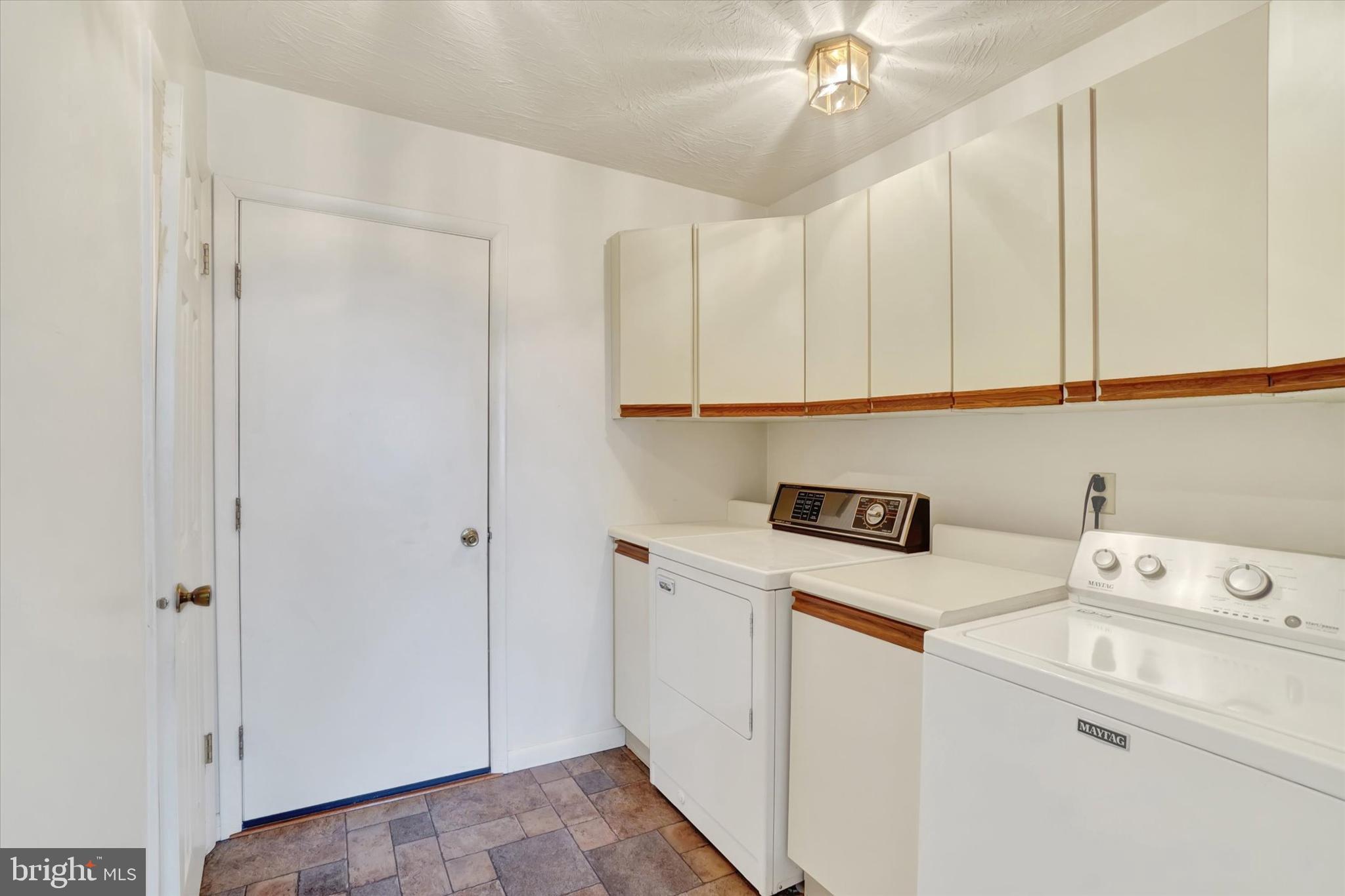 34 Jean Lo Way York, PA 17406 - Photo 11 of 27 a view of cabinets with washer and dryer