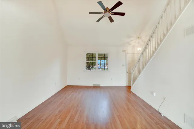 a view of an empty room and wooden floor