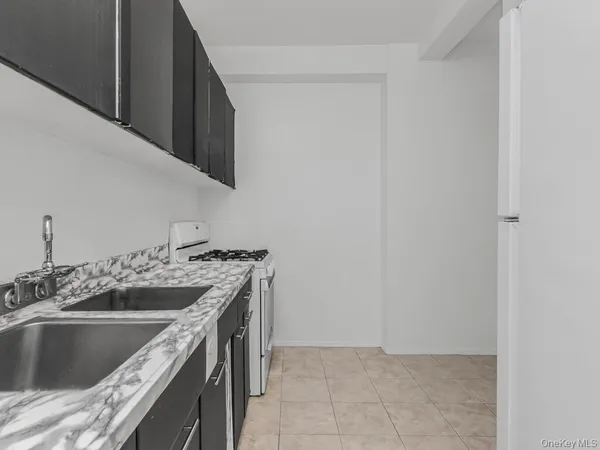 a kitchen with a sink and a stove top oven
