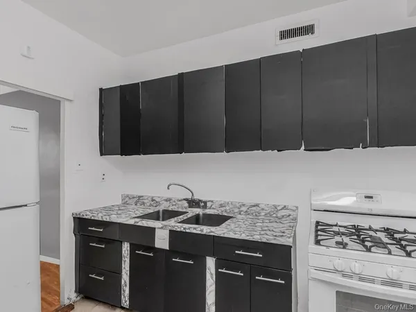a kitchen with granite countertop a stove and a sink