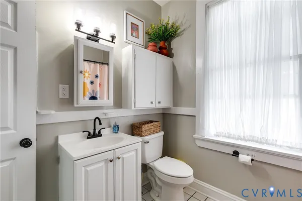 a bathroom with a sink a toilet and vanity