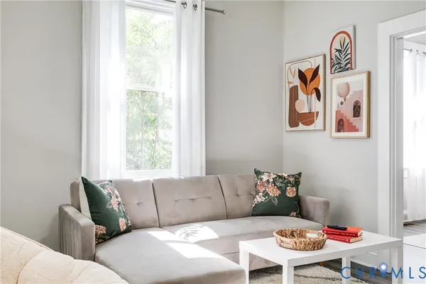 a living room with furniture and a flat screen tv