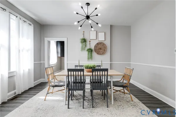 a view of a dining room and chandelier fan and wooden floor