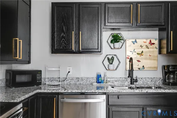 a kitchen with stainless steel appliances a sink stove and cabinets