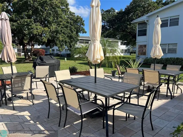 a view of an outdoor space with table and chairs