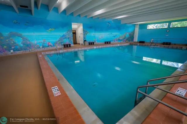 a view of a swimming pool with a yard