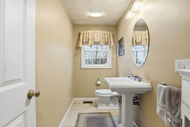 a bathroom with a sink toilet and a mirror