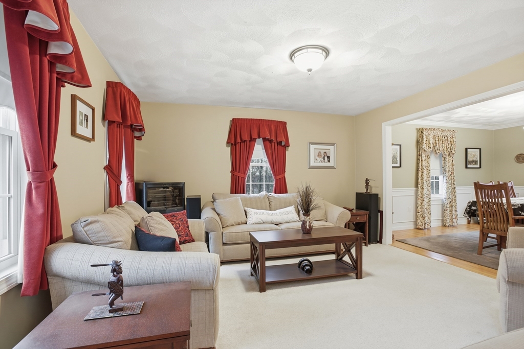 233 Bartholomew Street Peabody, MA 01960 - Photo 14 of 37 a living room with furniture and a mirror