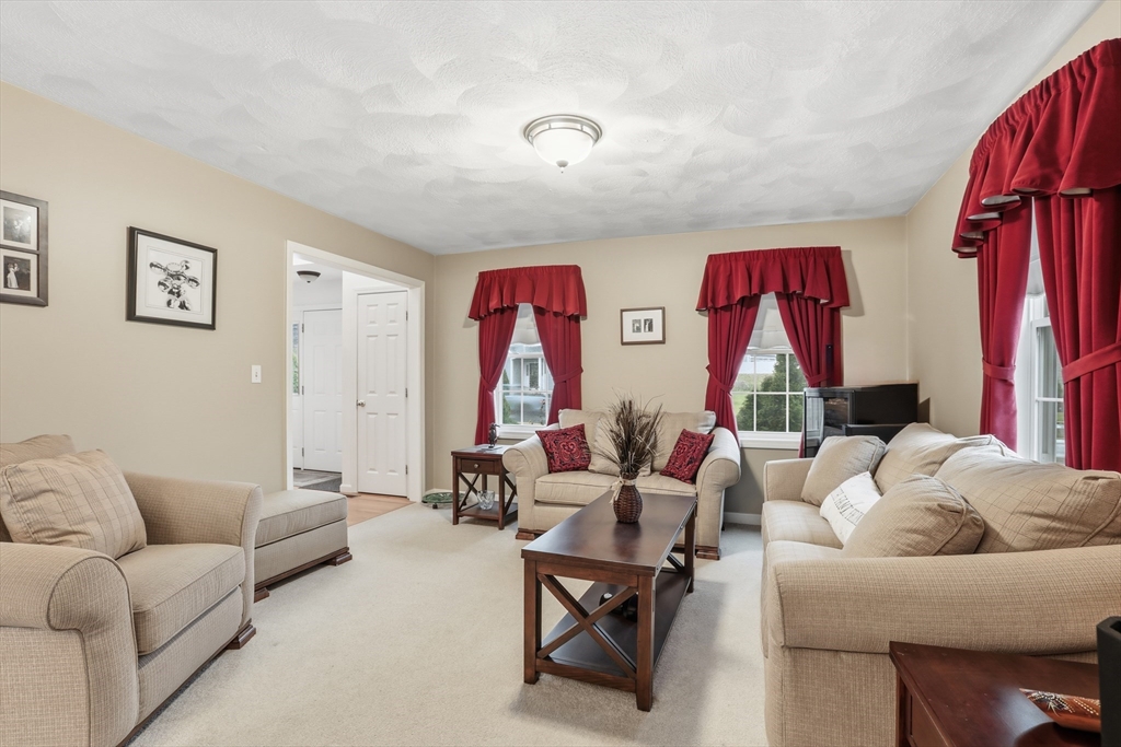 233 Bartholomew Street Peabody, MA 01960 - Photo 16 of 37 a living room with furniture a rug and a wooden floor