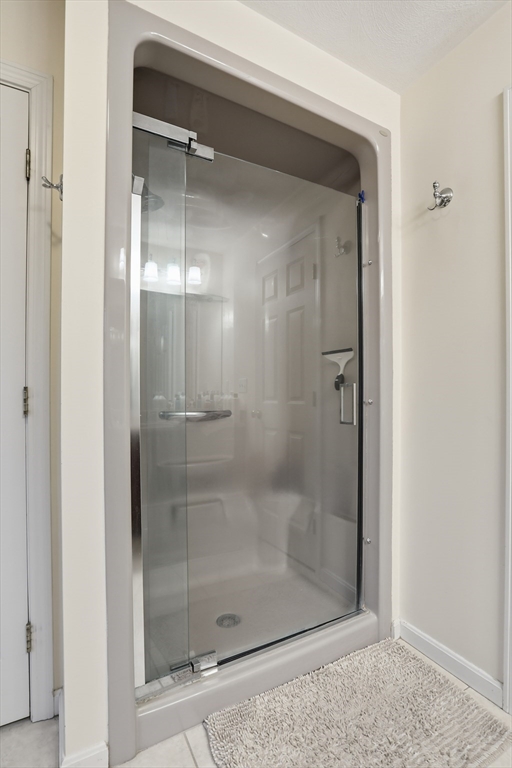 233 Bartholomew Street Peabody, MA 01960 - Photo 26 of 37 a bathroom with a glass shower door