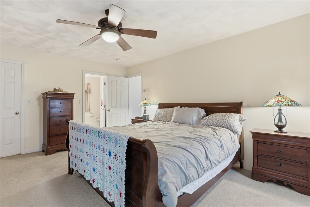 233 Bartholomew Street Peabody, MA 01960 - Photo 30 of 37 a bedroom with a bed and a chandelier
