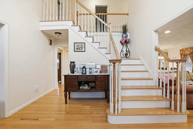 a view of entryway and hall with wooden floor