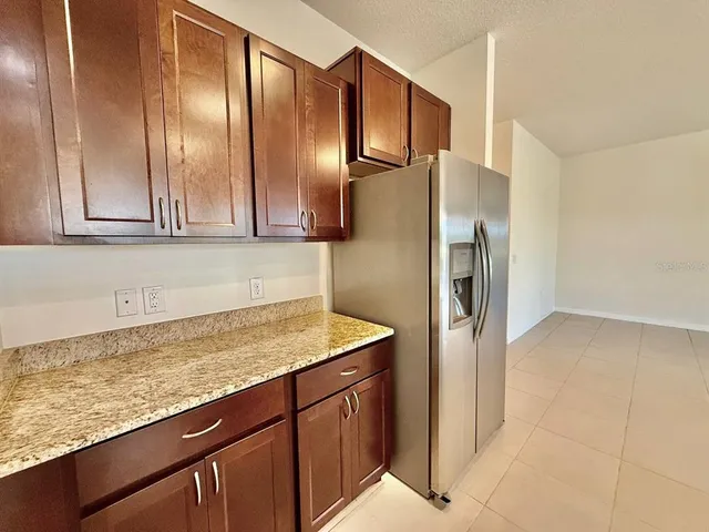 a kitchen with stainless steel appliances granite countertop a sink a stove top oven and granite counter tops