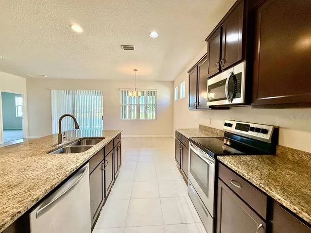 a view of an empty room with chandelier