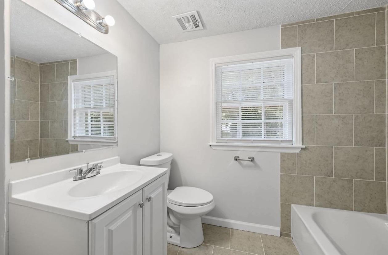 3843 Blue Jay Road Memphis, TN 38116 - Photo 19 of 23 a bathroom with a sink toilet vanity and window