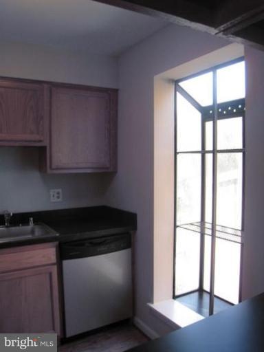 35 Andrew Place, Unit R112 Baltimore, MD 21201 - Photo 14 of 20 a kitchen with stainless steel appliances granite countertop a stove a sink and a microwave