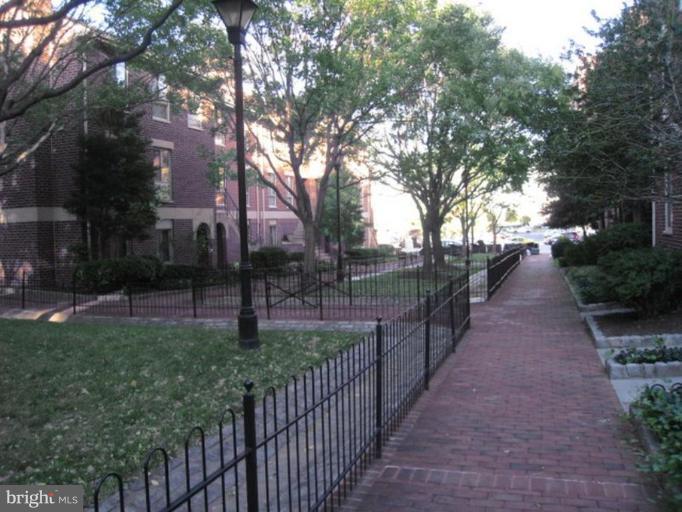 35 Andrew Place, Unit R112 Baltimore, MD 21201 - Photo 3 of 20 a view of a pathway with a wrought fence