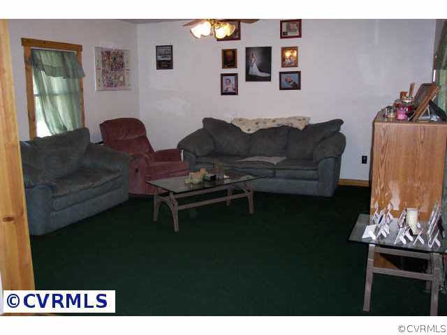 242 Buckner Road Bumpass, VA 23024 - Photo 2 of 5 a living room with furniture and a rug