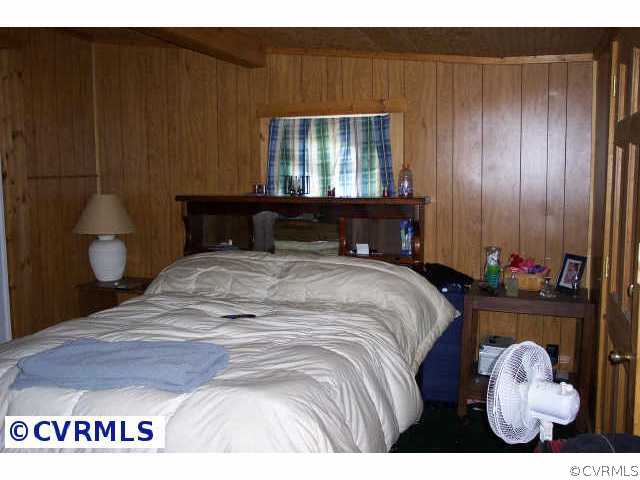 242 Buckner Road Bumpass, VA 23024 - Photo 3 of 5 a bedroom with a bed and a window