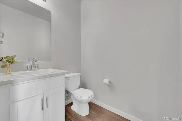 a bathroom with a toilet sink and vanity