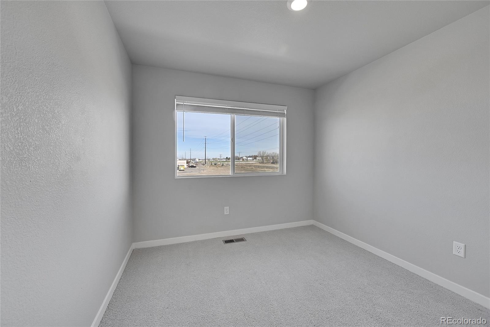 1353 Reynolds Street, Unit 3C Fort Lupton, CO 80621 - Photo 16 of 31 an empty room with a window