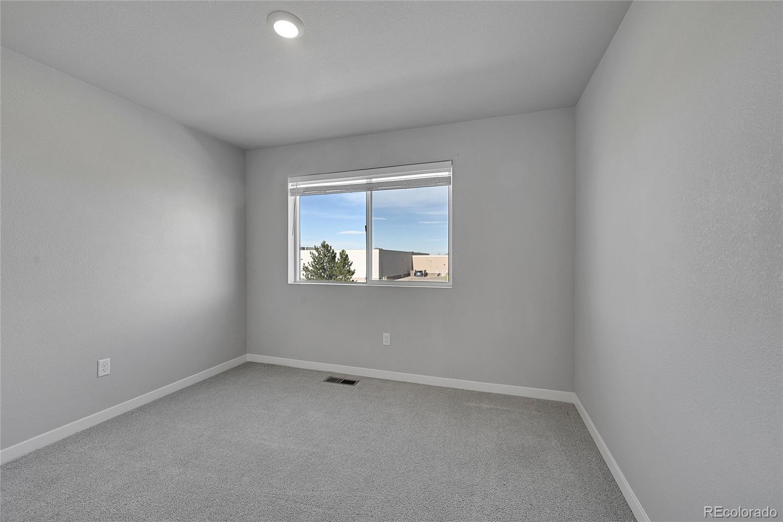 1353 Reynolds Street, Unit 3C Fort Lupton, CO 80621 - Photo 18 of 31 an empty room with a window