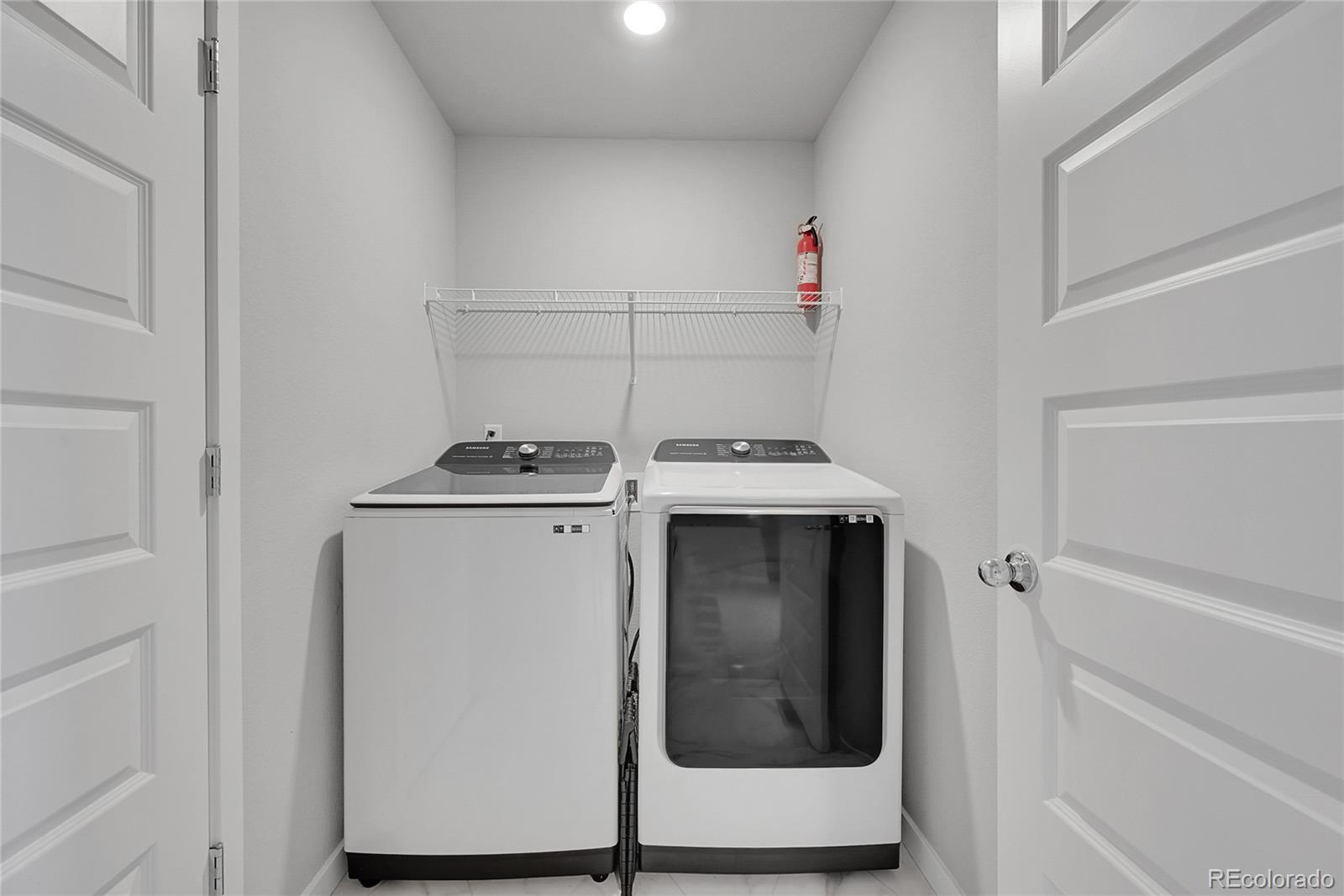 1353 Reynolds Street, Unit 3C Fort Lupton, CO 80621 - Photo 21 of 31 a utility room with washer and dryer