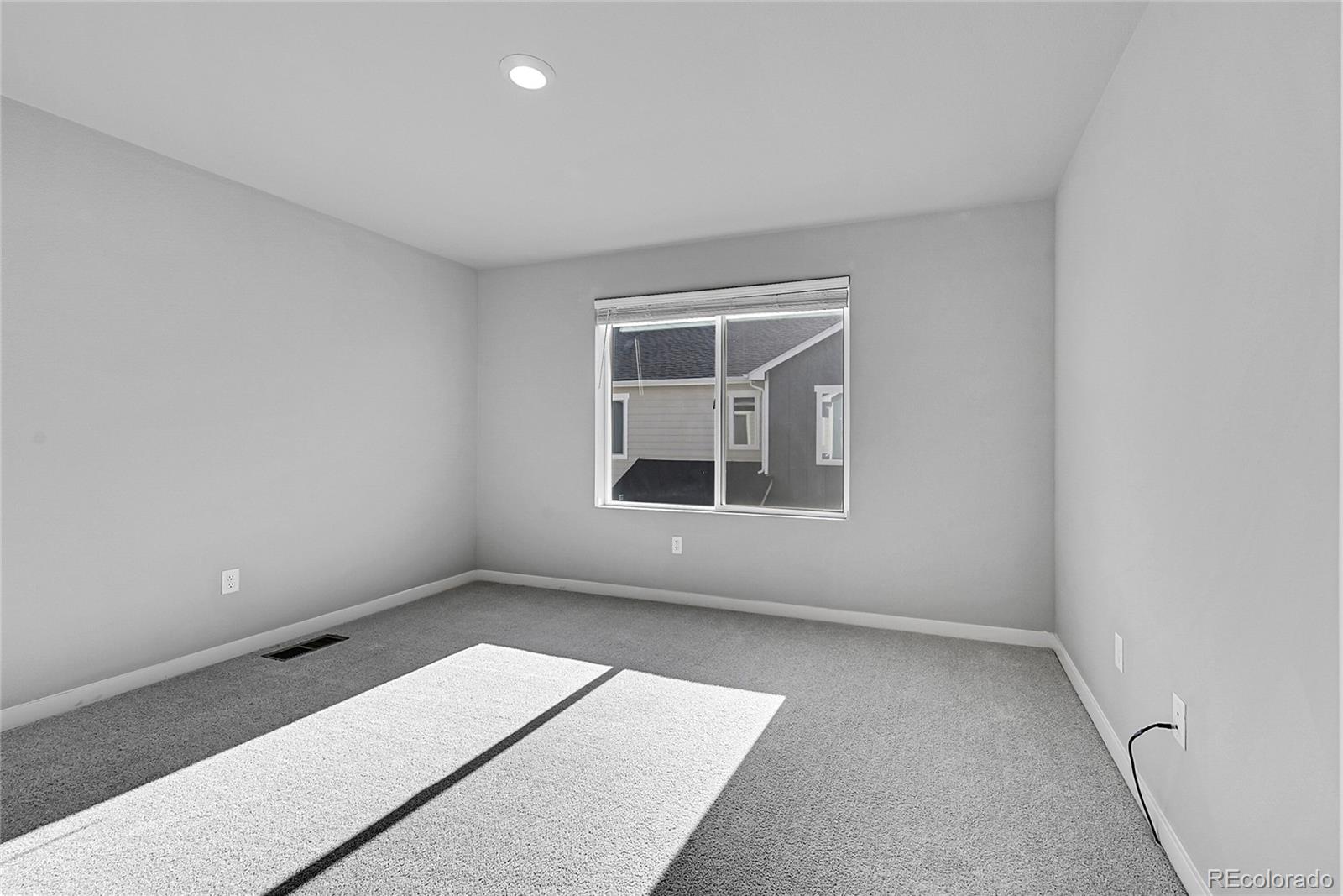 1353 Reynolds Street, Unit 3C Fort Lupton, CO 80621 - Photo 22 of 31 an empty room with a window