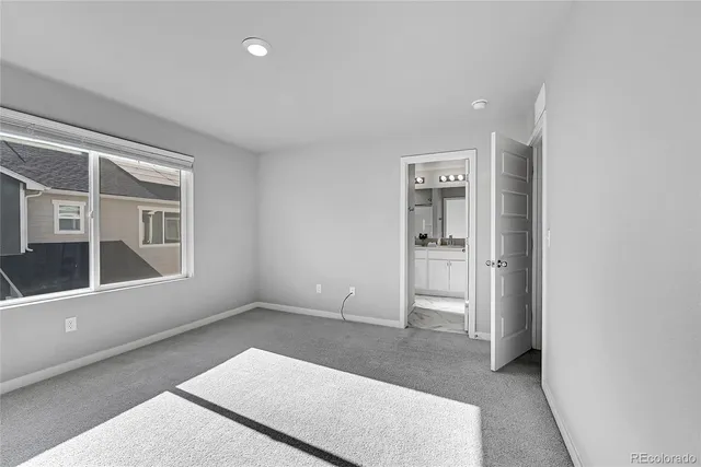 an empty room with entrance and windows