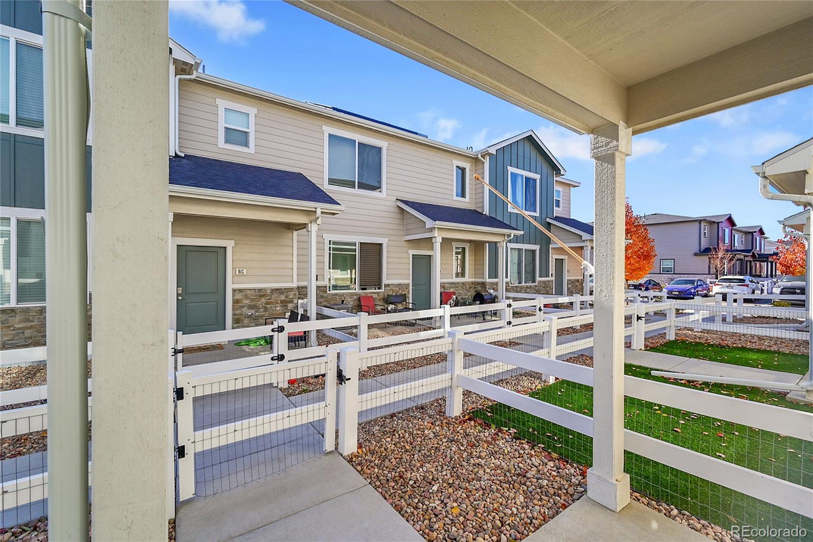 1353 Reynolds Street, Unit 3C Fort Lupton, CO 80621 - Photo 4 of 31 a view of residential house with wooden floor and fence
