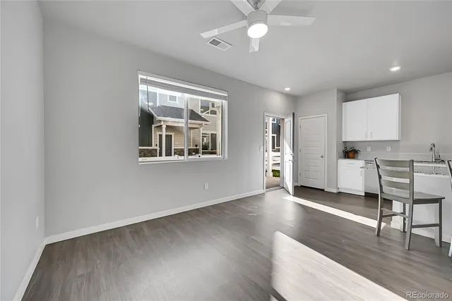a view of a kitchen with wooden floor and a window
