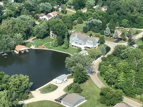 an aerial view of a house with a yard