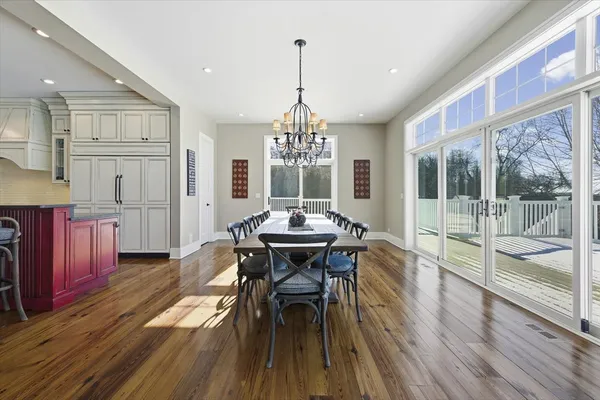a kitchen with stainless steel appliances granite countertop a lot of counter space and a wooden floor