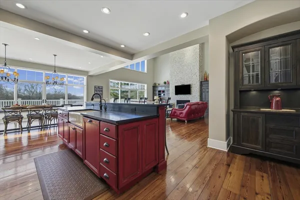 a bathroom with a granite countertop toilet a sink and a mirror
