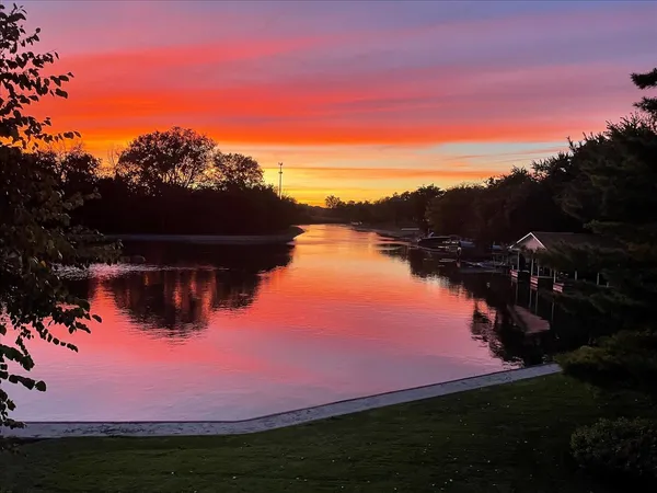 an aerial view of residential house with outdoor space and river