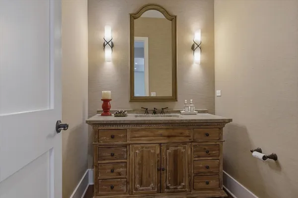 a bathroom with a toilet a sink and mirror