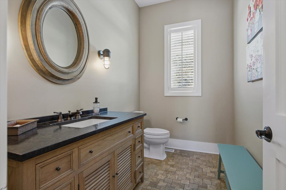 38778 North Ackerman Road Antioch, IL 60002 - Photo 39 of 97 a bathroom with a granite countertop toilet a sink and a mirror