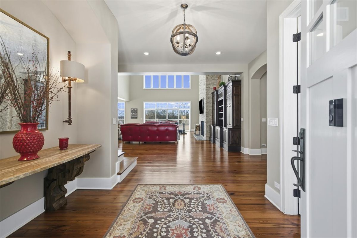38778 North Ackerman Road Antioch, IL 60002 - Photo 5 of 82 a hallway with a dining table and chairs